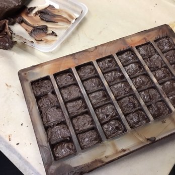 CocoTutti Chocolates - a tray of chocolates on a counter - Chocolatiers & Shops Near Me - Brisbane, California