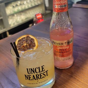 Swallow's Nest - a drink and a bottle on a bar - Cocktail Bars Near Me - Houston, Texas