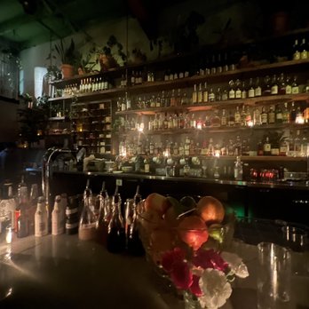 Flamingo Room - a bar with a lot of bottles and candles - Cocktail Bars Near Me - Bend, Oregon