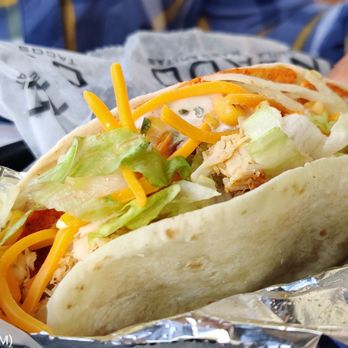 Condado Tacos - a person holding a taco - Tacos Near Me - Pittsburgh, Pennsylvania