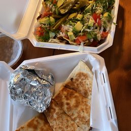 a meal in a styrofoam container and a salad in a styrofoam container a meal in a styrofoam container and a salad in a styrofoam container