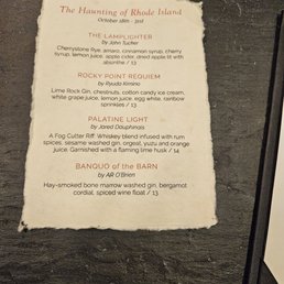 A textured paper menu with torn edges features four cocktails inspired by Rhode Island, including ingredients and prices.