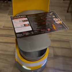 Friendly robot leading us to the table!