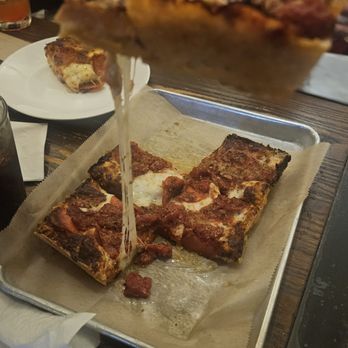 Uno Pizzeria & Grill - cheese pull on Detroit Imperial Pepperoni pizza - Pizza Near Me - Orlando, Florida