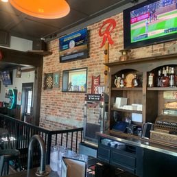 a bar with a brick wall a bar with a brick wall