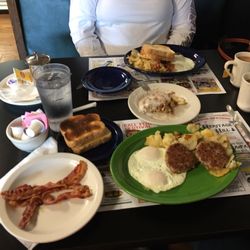 Cafe Contrary - Two breakfast specials with an extra Side of bacon and a cinnamon roll. And my wife....