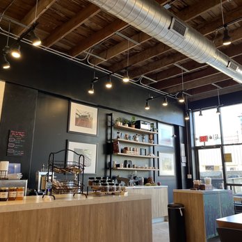 Mozna Chocolate And Coffee - Looking toward front of store from well-padded bench with tables. - Chocolatiers & Shops Near Me - San Antonio, Texas Mozna Chocolate And Coffee - Looking toward front of store from well-padded bench with tables. - Chocolatiers & Shops Near Me - San Antonio, Texas