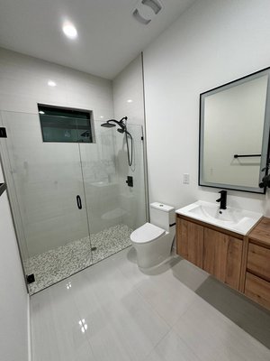Modern Bathroom Tile Installation - Modern bathroom tile installation featuring large-format floor tile and a tiled walk-in shower with mosaic shower floor. Clean layout, precise cuts, consistent grout lines, and careful attention to finishing details. Modern Bathroom Tile Installation - Modern bathroom tile installation featuring large-format floor tile and a tiled walk-in shower with mosaic shower floor. Clean layout, precise cuts, consistent grout lines, and careful attention to finishing details.