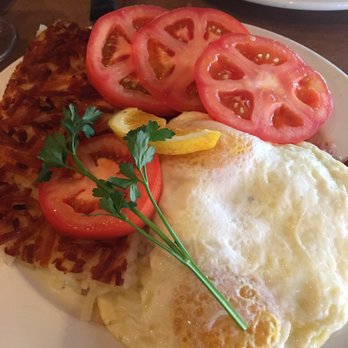 Tweet - Corned beef hash with over easy eggs, hash browns, and sliced tomatoes - New American Near Me - Chicago, Illinois