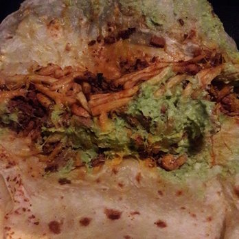 Cali Tacos - Cali Burrito opened: fries, guac, cheese, adobada. No sour cream for me! Meat was well seasoned. Everything mixed well, along with the sauce - Mexican Near Me - Orange, California
