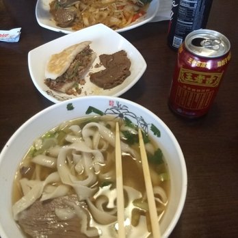 LanZhou Ramen - Lamb soup shaved noodles on the bottom, pork jia mo on the plate in the middle, and beef stir fried shaved noodles at the top. - Chinese Near Me - Doraville, Georgia LanZhou Ramen - Lamb soup shaved noodles on the bottom, pork jia mo on the plate in the middle, and beef stir fried shaved noodles at the top. - Chinese Near Me - Doraville, Georgia