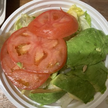 New Apolo - Avocado salad - A fresh salad featuring sliced tomatoes, avocado, and lettuce leaves served on a white disposable plate. - Chinese Near Me - Brooklyn, New York