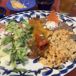 Chicken plate n cheese enchiladas rice n bean .