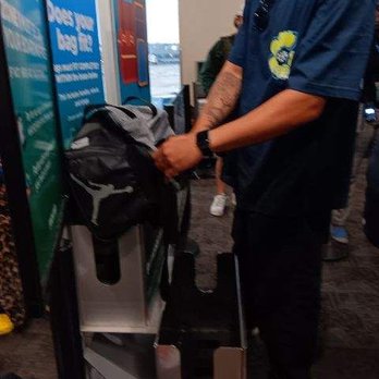 Frontier Airlines - Frontier allowing customer to remove items from their personal item to fit in bag checker then putting items back in. - Airlines Near Me - Denver, Colorado