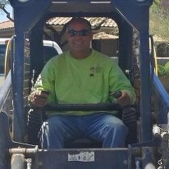 Arizona Desert Bloom Landscape - a man driving a tractor - Landscaping Near Me - Marana, Arizona Arizona Desert Bloom Landscape - a man driving a tractor - Landscaping Near Me - Marana, Arizona