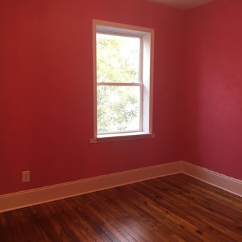 Quigley Construction - a room with a window and hardwood floors - General Contractors Near Me