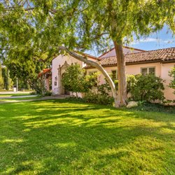 The stately 7,500 square foot clubhouse situated on a triple lot in Beverly Hills is surrounded by expansive lawn and lush gardens.