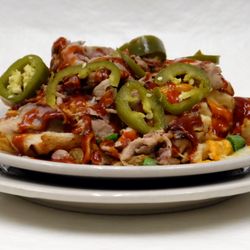 Wild Magnolia - BBQ Bacon Crack Fries - low & slow smoked pork, bacon, jalapenos, green onions, BBQ sauce and LOTS of cheese over waffle fries
