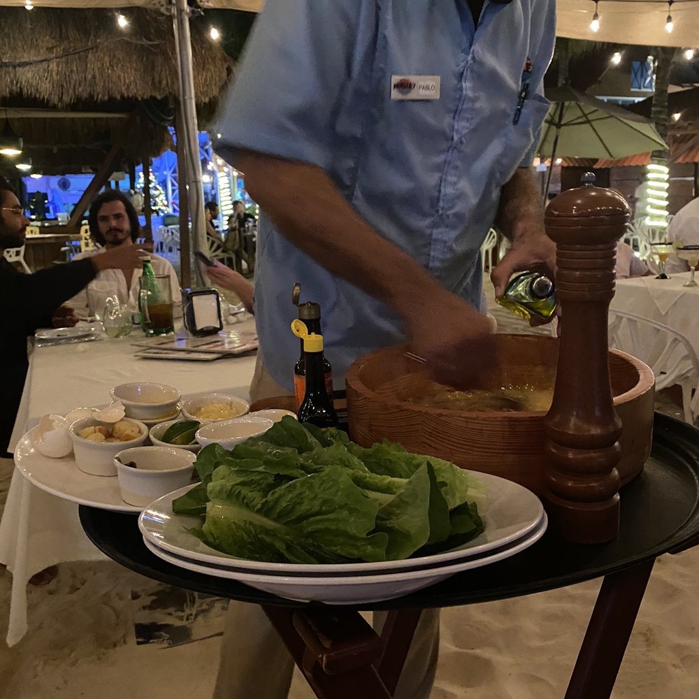 Muelle 7 - Making Caesar salad at the table - Cocktail Bars Near Me - Isla Mujeres, ROO