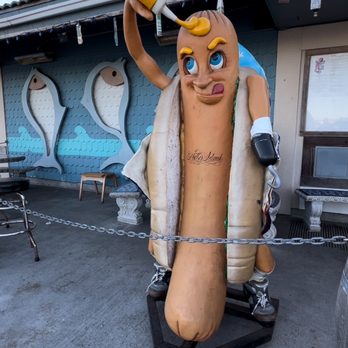 Fathom Bistro Bait & Tackle - You'll find this character and the bistro across the street from the Island Palms Hotel. - Hot Dogs Near Me - San Diego, California Fathom Bistro Bait & Tackle - You'll find this character and the bistro across the street from the Island Palms Hotel. - Hot Dogs Near Me - San Diego, California
