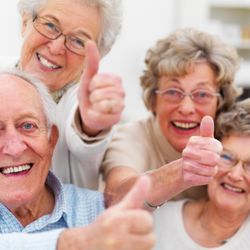 Tender Loving Care Senior Residence - Group of happy seniors smiles & thumbs up
