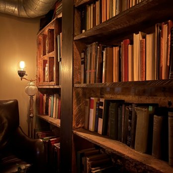 Bodega - a bookshelf full of books in a dimly lit room - Bars Near Me - Salt Lake City, Utah Bodega - a bookshelf full of books in a dimly lit room - Bars Near Me - Salt Lake City, Utah