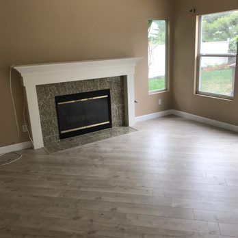OC Premium Flooring - a living room with a fireplace - Flooring Near Me OC Premium Flooring - a living room with a fireplace - Flooring Near Me