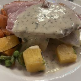 Pork steak over mashed potatoes with steamed vegetables Pork steak over mashed potatoes with steamed vegetables