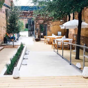 The 4 Eleven - Step foot through the rustic sliding door off Main Street and stroll through our quaint, ivy-covered Garden Patio. - Wedding Planning Near Me - Fort Worth, Texas The 4 Eleven - Step foot through the rustic sliding door off Main Street and stroll through our quaint, ivy-covered Garden Patio. - Wedding Planning Near Me - Fort Worth, Texas