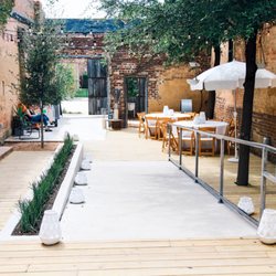 The 4 Eleven - Step foot through the rustic sliding door off Main Street and stroll through our quaint, ivy-covered Garden Patio.