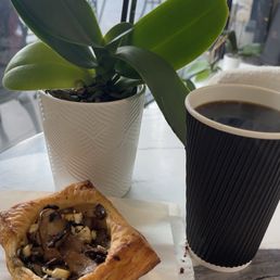 Mushroom feta pastry with a cup of regular drip coffee Mushroom feta pastry with a cup of regular drip coffee