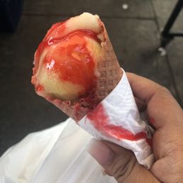 a hand holding an ice cream cone