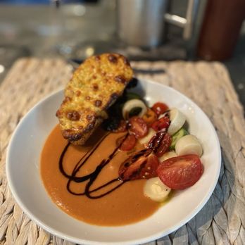Undiscovered Charleston - The first course, a cold gazpacho soup and pimento cheese toast. The perfect summer dish with fresh vegetable garnish. - Food Tours Near Me Undiscovered Charleston - The first course, a cold gazpacho soup and pimento cheese toast. The perfect summer dish with fresh vegetable garnish. - Food Tours Near Me