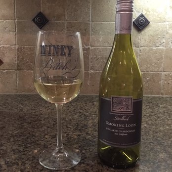 Harris Teeter - a glass of white wine next to a bottle of wine - Grocery Near Me - Greensboro, North Carolina
