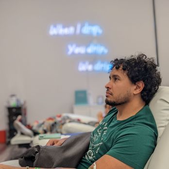 Revival IV Lounge - Colonial - Husband sitting in recliner watching tv - IV Hydration Near Me - Orlando, Florida Revival IV Lounge - Colonial - Husband sitting in recliner watching tv - IV Hydration Near Me - Orlando, Florida