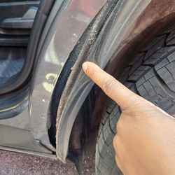 Budget Car and Truck Rental - Lining separated from passenger side rear wheel well, Ford Explorer