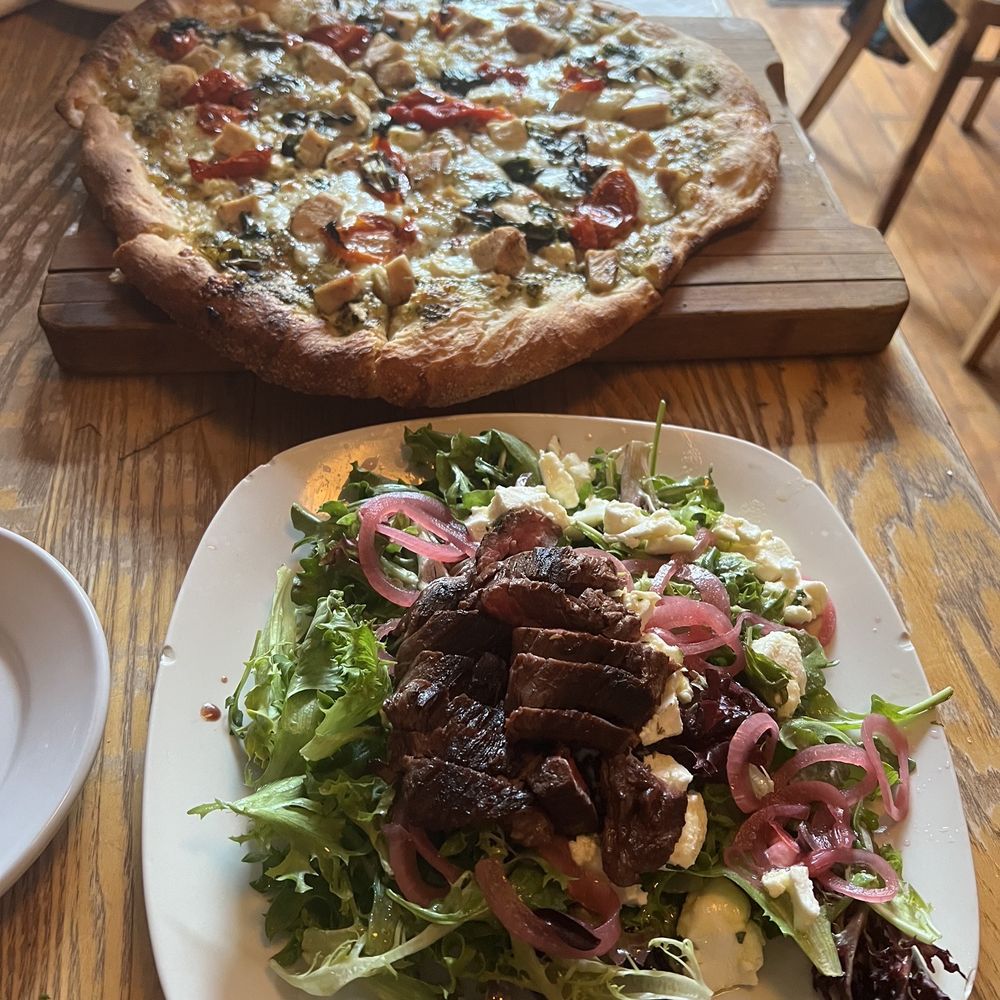 chicken pesto pizza (pizza of the day) and goat cheese salad with hangar steak