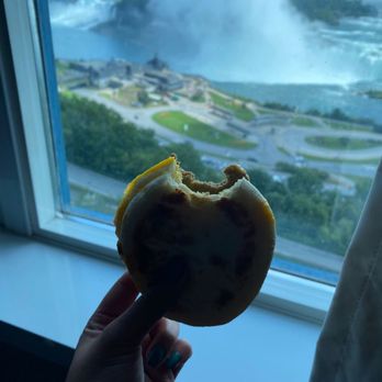Starbucks - a person holding a half eaten donut in front of a window - Coffee & Tea Near Me - Niagara Falls, Ontario Starbucks - a person holding a half eaten donut in front of a window - Coffee & Tea Near Me - Niagara Falls, Ontario