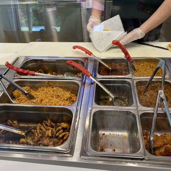 Guasaca - a person preparing food at a buffet - Venezuelan Near Me - Durham, North Carolina