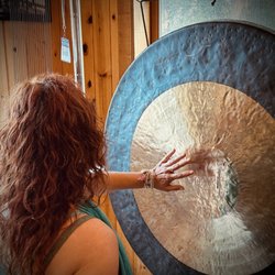 Julia Francis Sound Therapy - Julia Francis plays the gong during her transformational and deeply relaxing sound baths.