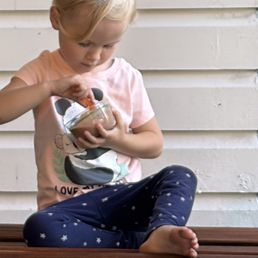 My baby girl happily eating her single scoop chocolate ice cream My baby girl happily eating her single scoop chocolate ice cream
