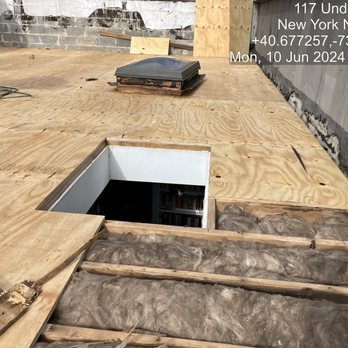 William & Hugh Roofing - New plywood around apartment skylight. New insulation in foreground. - Roofing Near Me - Sunnyside, New York