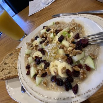 Good Evans - Steel cut oats with sliced banana, apples, dried fruit, walnuts & honey comb with a side of wheat toast - Breakfast & Brunch Near Me - Lincoln, Nebraska