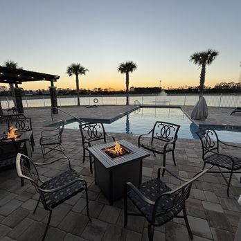 St. Augustine RV Resort - Clubhouse patio, fire tables and pool at sunset - RV Parks Near Me - St. Augustine, Florida St. Augustine RV Resort - Clubhouse patio, fire tables and pool at sunset - RV Parks Near Me - St. Augustine, Florida