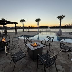 St. Augustine RV Resort - Clubhouse patio, fire tables and pool at sunset