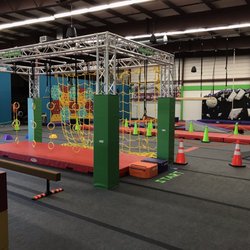 EVO Kids - Interior with some of the ninja equipment. Bouldering walls in back.