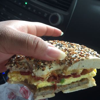 Big Apple Bagels - a hand holding a sandwich - Bagels Near Me - Northbrook, Illinois