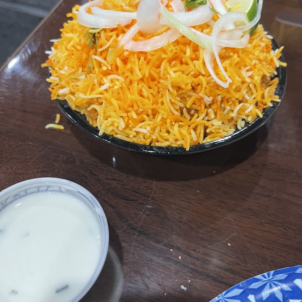 Paradise Biryani Pointe - a plate of biryani rice and a bowl of yogurt - Indian Near Me - Catonsville, Maryland Paradise Biryani Pointe - a plate of biryani rice and a bowl of yogurt - Indian Near Me - Catonsville, Maryland