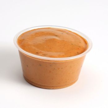Slim Chickens - a plastic cup filled with sauce - Chicken Wings Near Me - Texarkana, Texas Slim Chickens - a plastic cup filled with sauce - Chicken Wings Near Me - Texarkana, Texas