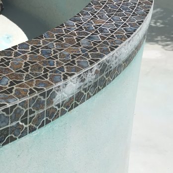 Zim's Pool Service and Repairs - The calcified damage is visible on the outer rim. The surface tile shows the difference after sand blasting - Pool Cleaners Near Me